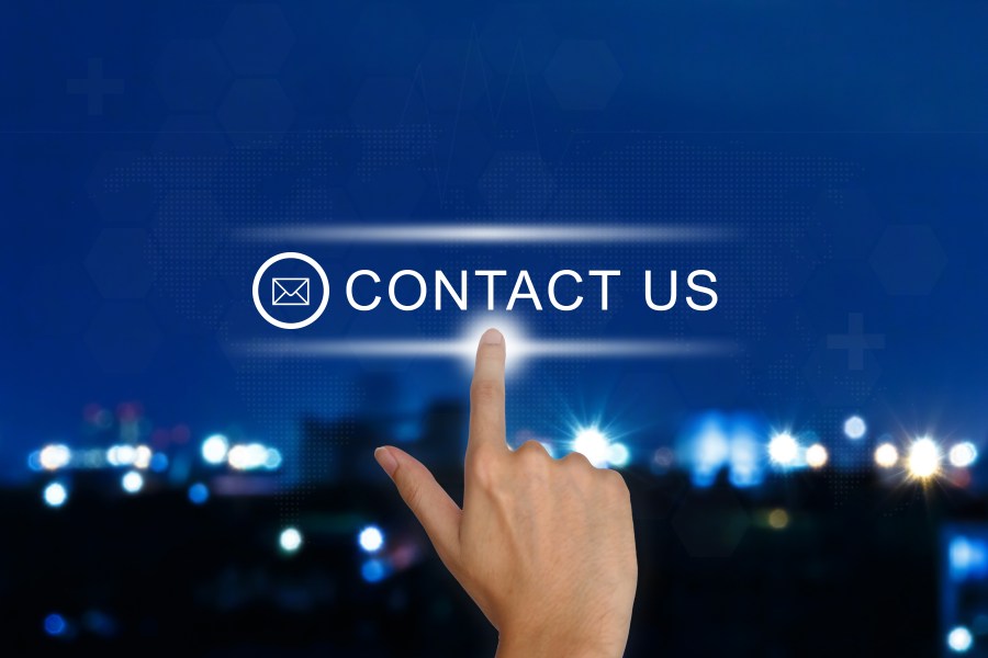 hand pushing contact us button on touch screen